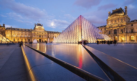 View of the Louvre Museum and the Pyramid at twilight.